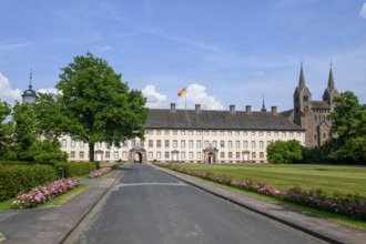 View across driveway with flower-lined street to Corvey Castle and Monastery, Höxter, North