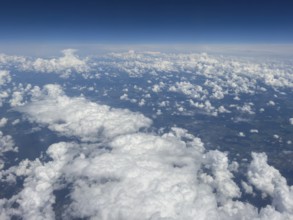 Aerial view from aeroplane at high altitude of white, bright cluster clouds Altocumulus,