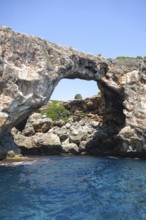 Natural rock arch at Cala Varques on the east coast of the Mediterranean island of Majorca between