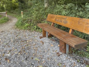 Wooden bench RVR bench with branded lettering Regionalverband Ruhr on cycle path Hiking trail in