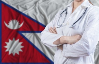 Doctor with crossed arms on Nepal flag. Nepali health and care concept. Female doctor on Nepal flag
