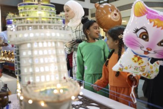 Syrian artisans display handmade artistic pieces to visitors at the Damascus International Fair.