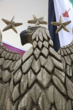 A large sculpture of Syria's national emblem eagle is displayed inside a pavilion at the Damascus