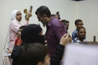 A Syrian puppeteer entertains children at the Damascus International Fair by imitating the role of