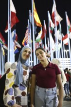 Visitors take souvenir photos at the central square of the Damascus International Fair, with the
