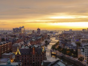 Aerial view of the Speicherstadt Hamburg with evening lighting and view over the harbour with