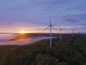 Wind turbines above a fog-covered forest in golden sunlight, sunrise, near Schorndorf, Rems-Murr
