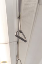 Close-up of the grab rails on the ceiling of a train, battery Electric train with green