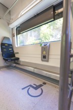 Train compartment with marked area for wheelchairs, battery Electric train with green electricity,
