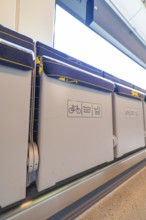 Train interior with folding seats and bright lights, battery Electric train with green electricity,