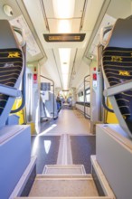 Modern train interior with bright colours and modern seats, battery Electric train with green