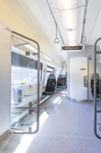 Modern and bright train interior with empty seats and lighting, battery Electric train with green