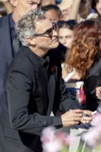 Venice, Italy - 3 September 2025: Joaquin Phoenix signing autographs during the Red Carpet of - The