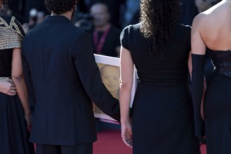 Venice, Italy - 3 September 2025: Motaz Malhees with a portrait of five-year-old Palestinian girl