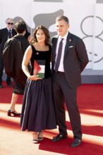 Venice, Italy - 3 September 2025: A guest carries a handbag designed in the colours of the