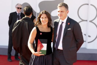 Venice, Italy - 3 September 2025: A guest carries a handbag designed in the colours of the