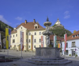 Main square with fountain in the background Filialkirche St. Peter am Petersberg, Friesach,