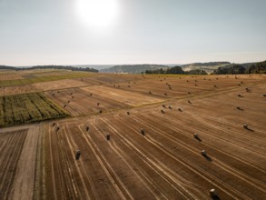 Spacious fields with straw bales under a bright sky, quiet and summery, Gechingen, district of
