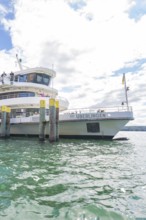 A ship is anchored in the harbour of Überlingen in the sunshine, Lake Constance, Germany