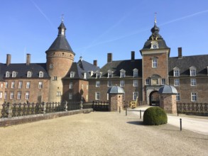 View of entrance portal and towers of moated castle moated castle Schloss Anholt, Isselburg, North