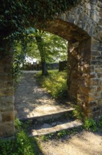View from former kennel outside of castle to former castle gate entrance to today's castle ruins