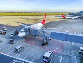 View of passenger aircraft of Air Malta at finger bridge for boarding disembarking passengers in