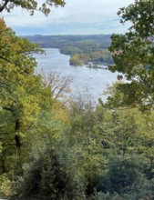 View through treetops of mixed forest Schellenberger Wald in late summer to Lake Baldeney, Essen,