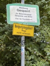 Below warning sign in mountain damage area with mountain damage Do not leave paths Above