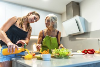 Two women preparing a healthy meal in a contemporary kitchen, focusing on fresh ingredients like