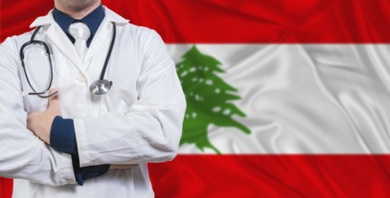 Male doctor with stethoscope on Lebanese flag. Doctor holding stethoscope on Lebanon flag