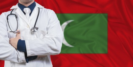 Male doctor with stethoscope on Maldivian flag. Doctor holding stethoscope on Maldives flag