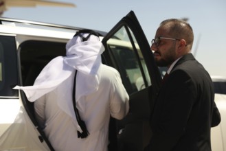 Officials from the Qatari and Syrian Red Crescents receive a Qatari airlift of aid to help the
