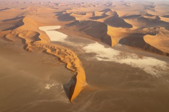 Sand dunes and dry pans in the Namib Desert. In the evening. Aerial view. Namib-Naukluft Park,