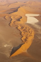 Sand dunes and dry pans in the Namib Desert. In the evening. Aerial view. Namib-Naukluft Park,