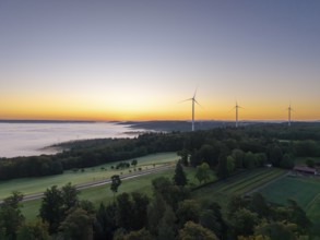 Expansive landscape with wind turbines and a veil of mist at dawn, near Schorndorf, Rems-Murr