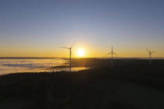 Wind turbines above a misty landscape at sunrise, near Schorndorf, Rems-Murr district,