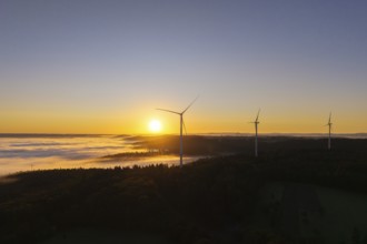 Three wind turbines towering in the morning landscape with fog, near Schorndorf, Rems-Murr-Kreis,