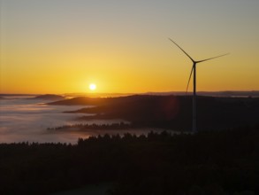 Impressive sunrise with wind turbine over foggy forest, near Schorndorf, Remstal, Rems-Murr-Kreis,