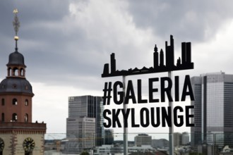 View of the Gallaria Skylounge sign with St Catherine's Church and the banking district with the