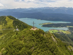 Panoramic view over a mountain and lake landscape with a cross on the summit, Herzogstand summit,