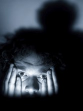 A close-up of a man whose face is marked by fear, symbolising anxiety disorders, panic attacks,