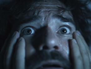 A close-up of a man whose face is marked by fear, symbolising anxiety disorders, panic attacks,
