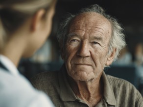 A young carer lovingly looks after a senior in a retirement home, nursing home, symbolic image for
