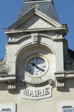 This French city hall features an elegant clock tower with a classic face, highlighting the