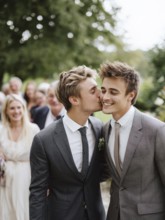 A male couple in a suit, one kissing the other on the cheek, surrounded by guests outdoors,