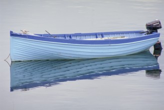 Fishing boat reflected on the lake, England, Great Britain