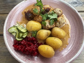 Traditional Swedish dish: Meatballs with potatoes and lingonberries on a plate in Ystad, Skåne