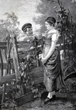Conversation at the garden fence, young man talking to young woman about a wooden fence in the