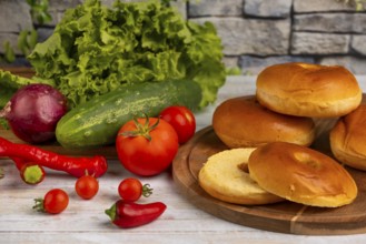 A selection of fresh ingredients such as tomatoes, cucumber, lettuce and bagels