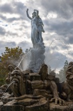 Undine Fountain with dramatic sky in the spa garden Baden, Lower Austria, Austria